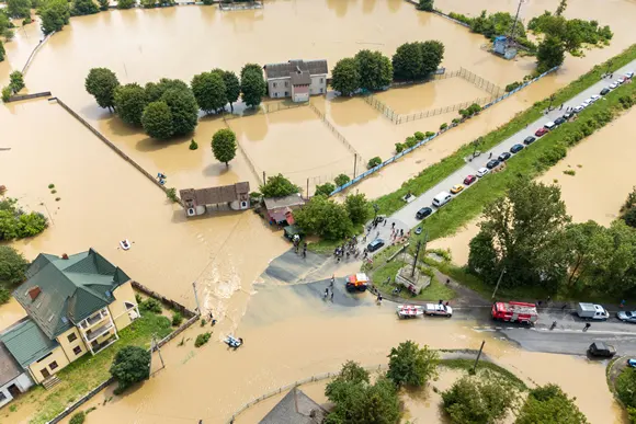 Aerial view of flooded houses and rescue vehicles saving people in town