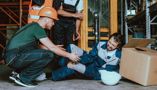 A construction worker helping an injured worker