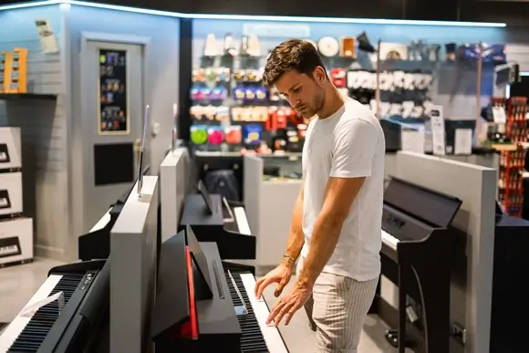 attentive customer choosing piano music store