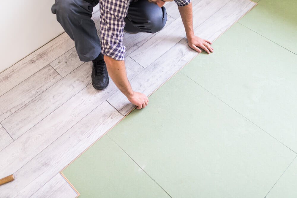 worker processing flooring board