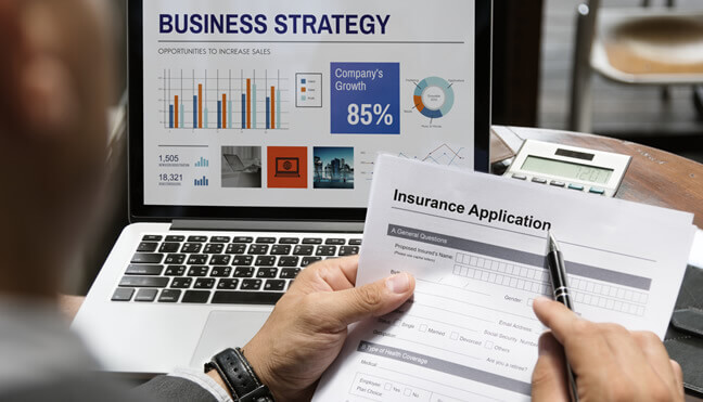 A person checking an Insurance Application while checking the business strategy